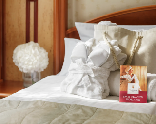 Wellnesstasche mit Bademantel auf dem Bett